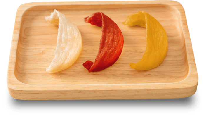 A group of colorful chips arranged on a wooden surface.